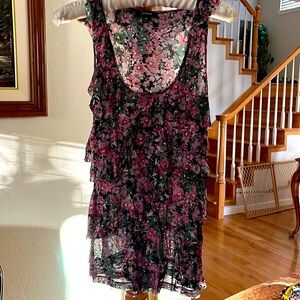 Floral top with layers of ruffles layer in rows on the front.